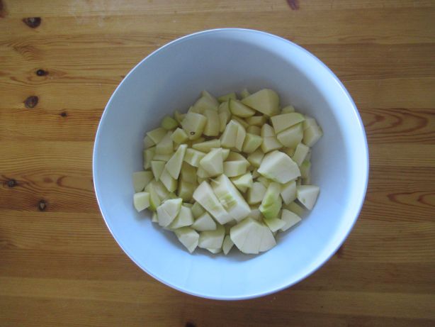 Die Äpfel schälen, rüsten und in kleine Stücke schneiden