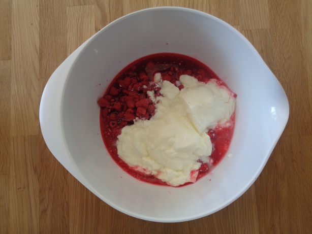 Add the raspberries and the natural yoghurt into a bowl