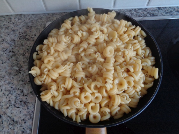 Remove the water and roast gently the pasta in a pan