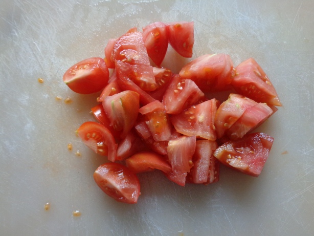 Die Tomaten in Stücke schneiden