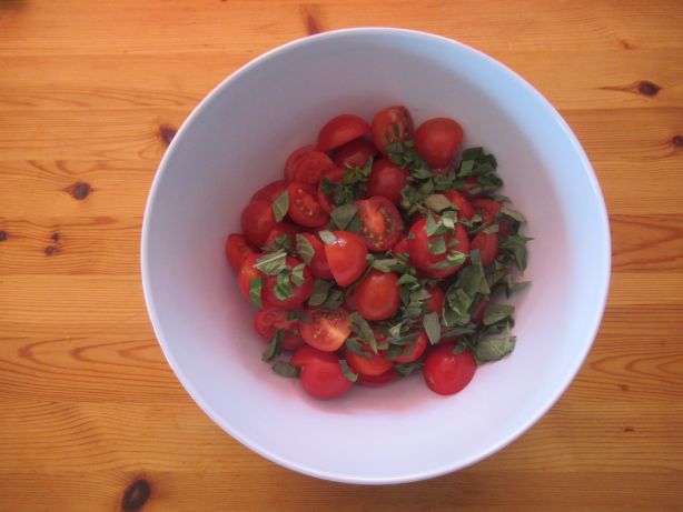 Cut the basil into pieces and add to the tomatoes