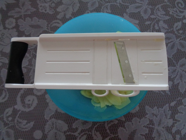 Kartoffeln schälen und in dünne Scheiben raffeln